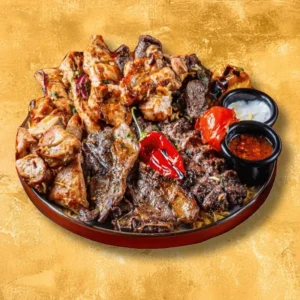 Bab Tooma’s Syrian mixed grill feast featuring charcoal-grilled chicken, lamb, kofta, roasted peppers and dipping sauces.